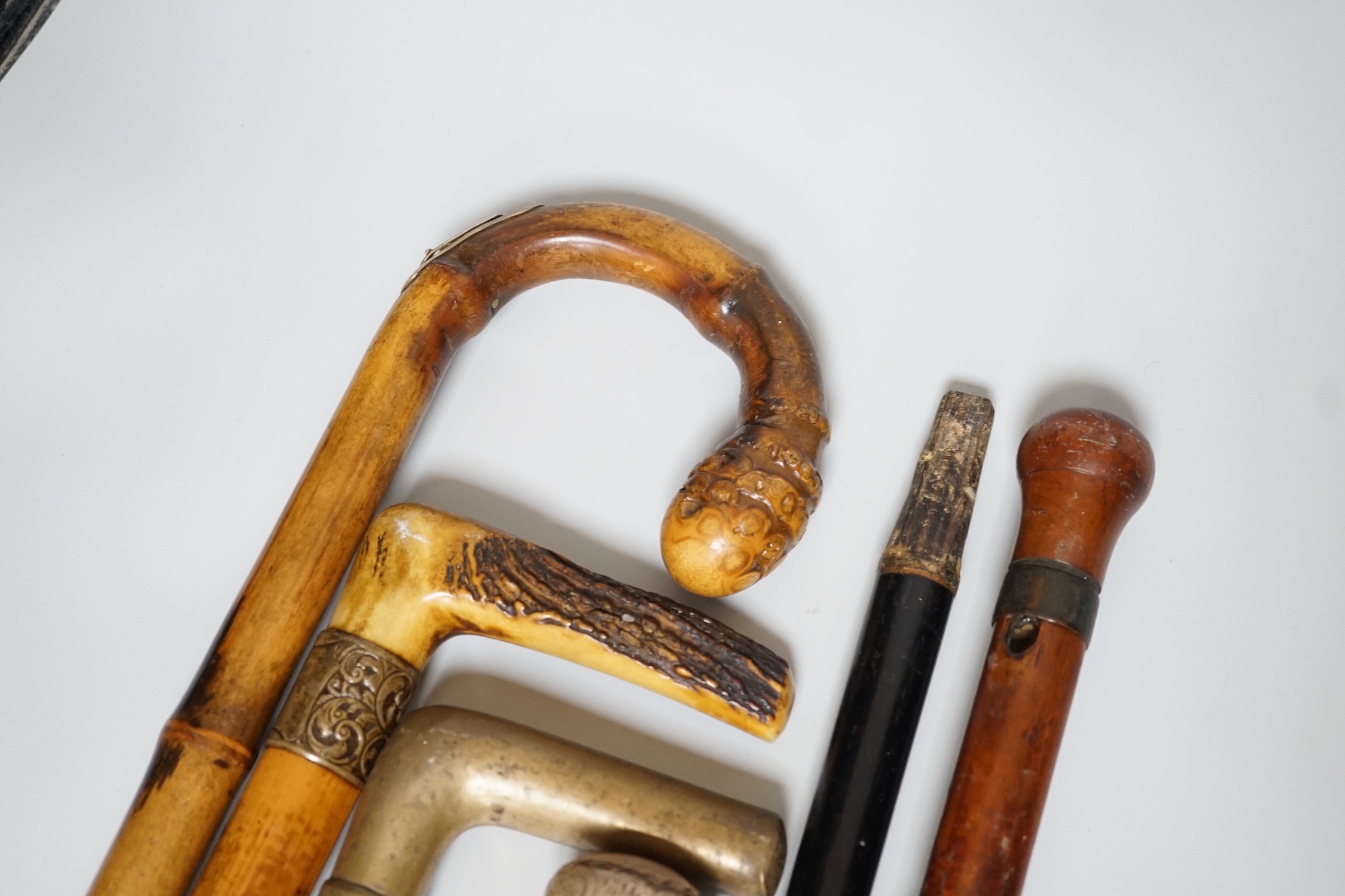 Two Victorian silver mounted walking sticks, a sword stick and three other sticks (6)